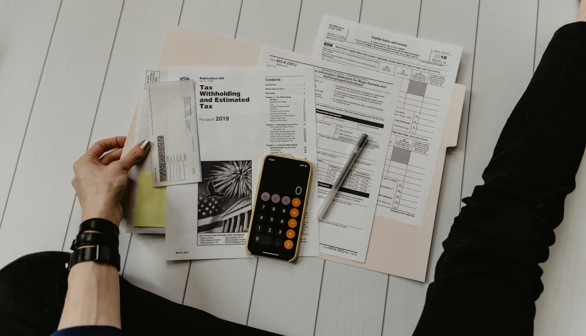 Tax forms, a pen and a calculator on a table